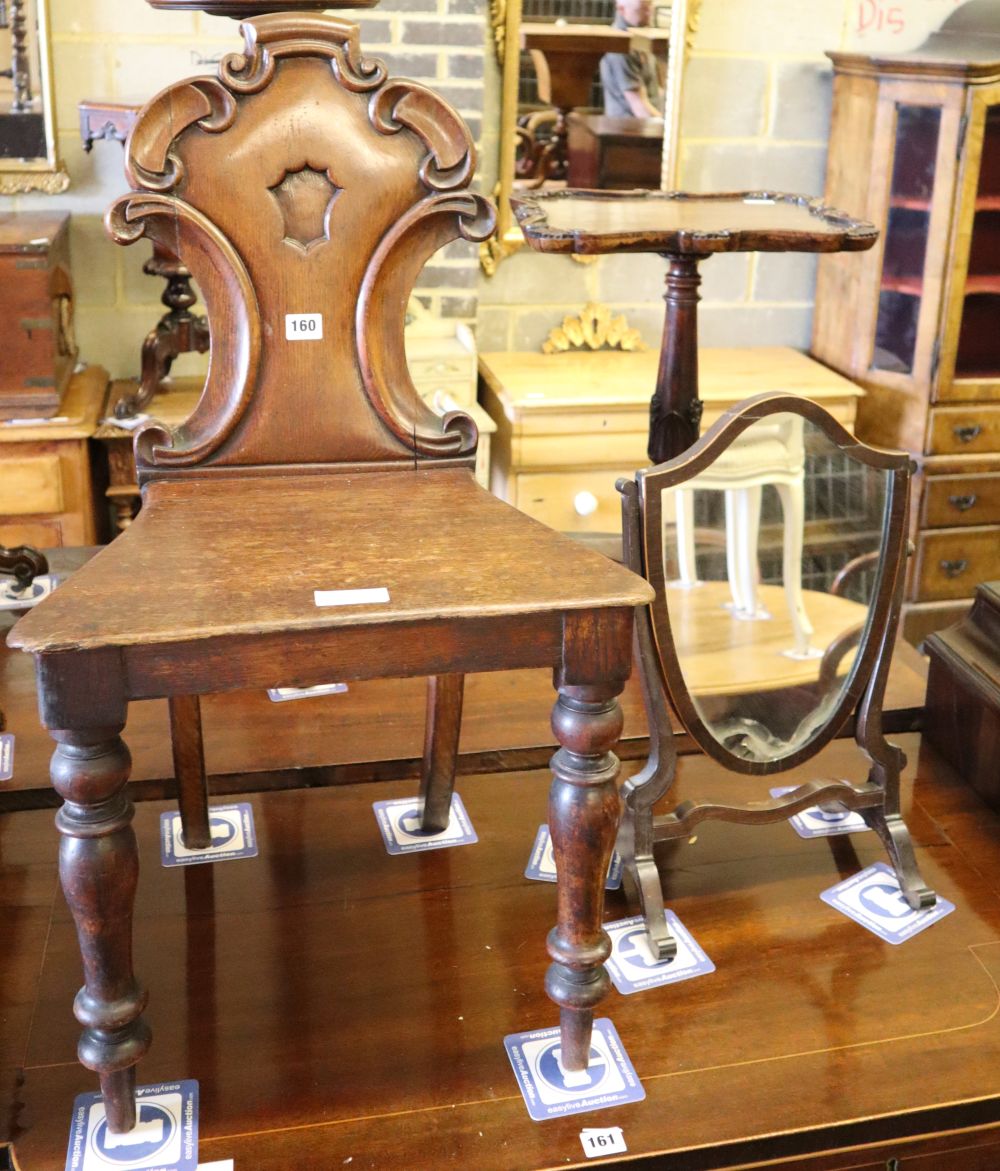 A Victorian carved oak hall chair and a skeleton framed toilet mirror